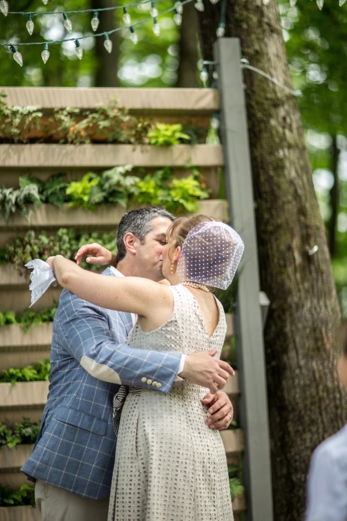 20th anniversary kiss Alisa Tongg Celebrant Family Vow Renewal at The Living Wall at Promise Ridge Jeremie Barlow Photography