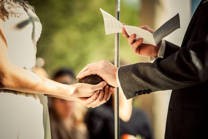 groom sets his promises into stone. oathing stone. alisa tongg celebrant. bill cardoni copy 2