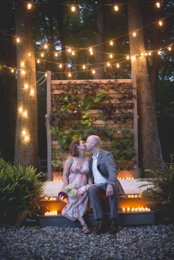 kissing on the stairs candlelit Blue Hour Elopement at The Living wall at Promise Ridge Rob Yaskovic Photography