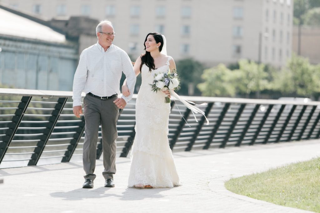 tiffany walks in with her father alisa tongg celebrant race street peir philadelphia wedding emily wren photography