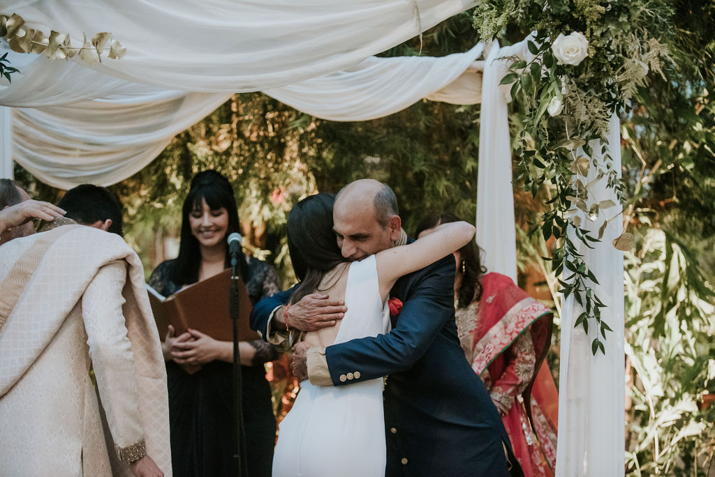 Family members embracing during a personal wedding ceremony led by celebrant Alisa Tongg.