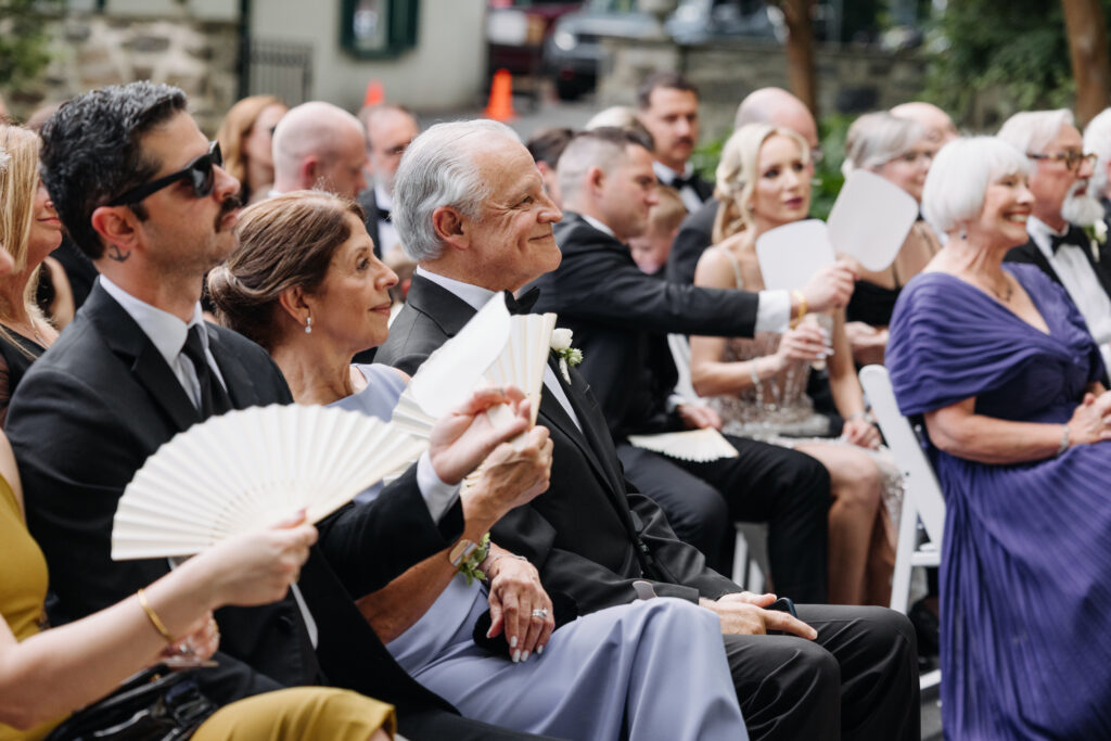 Wedding witnesses smiling and reacting together during a personal ceremony.